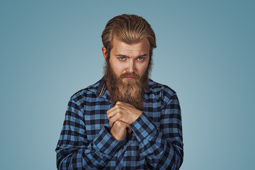 Man in unpleasant awkward situation playing nervously with hands.