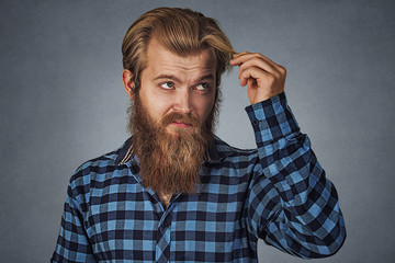upset man feeling head, surprised he is losing hair