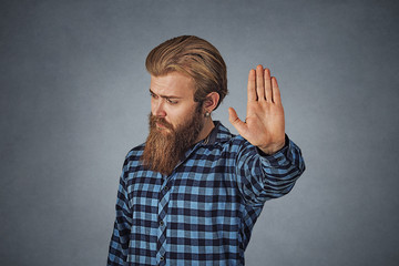 man raising hand up to say no stop right there