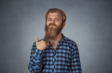Angry young man gesturing with hand to stop talking, cut it out