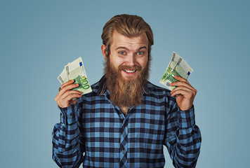 euphoric bearded man holding money in hands