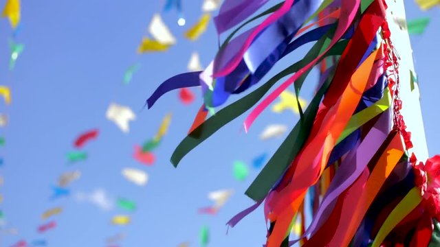 bottom view of typical Junina' Party ornament / decoration. Blue sky, colored tapes. Also, holiday and joy as a concept.