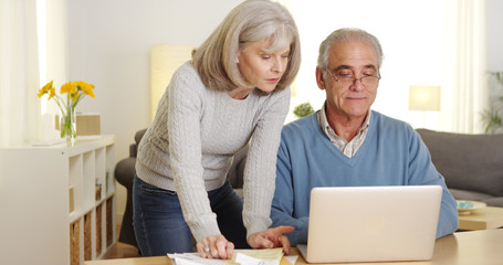 Mature couple doing finances on laptop computer