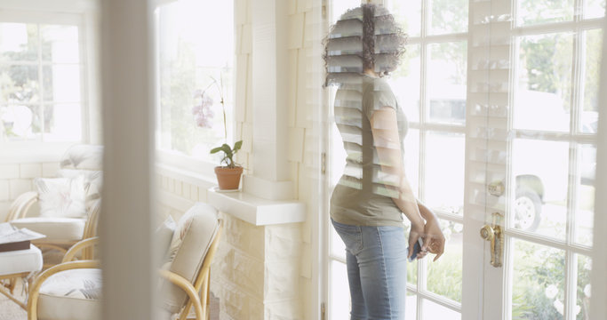 Young Attractive Black Woman Looking Out Patio Door