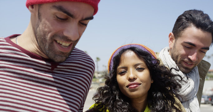 Group of young mulitracial friends hanging out at the beach