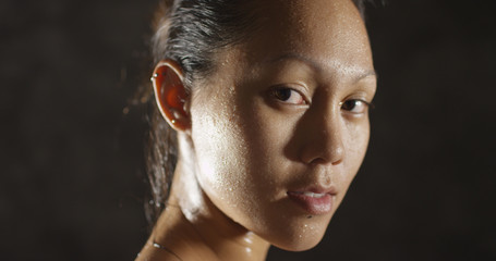Fitness Chinese athlete woman sweating looking at camera