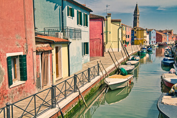 Small fishing boats line the canal in the quaint island of Burano, Italy, famous for it's colorful buildings.