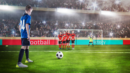 kid football player prepairing to take a shot on a football field