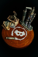 dollar bills are stacked in the form of a space Shuttle. Symbol of bitcoin in the form of drugs. Crumpled banknotes