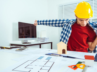 Asian man architect construction startup working on project.