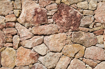 New wall of red stones closeup