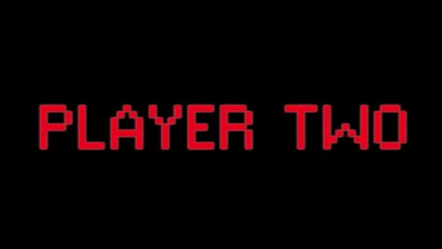 A flashing text with the words Player Two. Red on black, blocky 8-bit characters, faded color tone.
