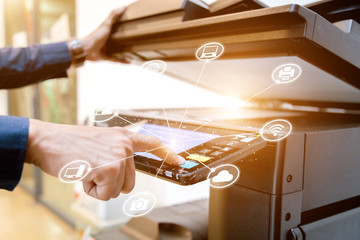 Bussiness man Hand press button on panel of printer with icon technology printer scanner laser office copy machine supplies start concept.
