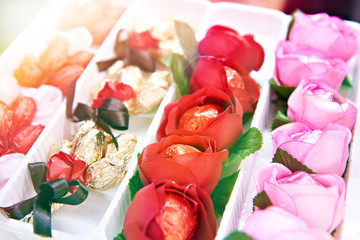 Sweets in flowers and beautiful wrappers on store