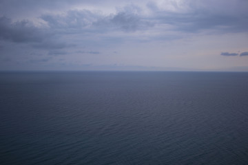 Seascape with sea horizon and almost clear deep blue sky - Background