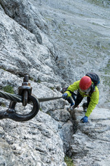 young attractive female mountain climber in the Dolomites of Italy