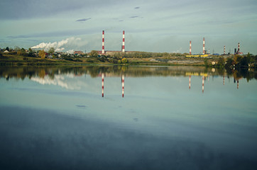 industrial landscape with smoking chimneys on the waterfront