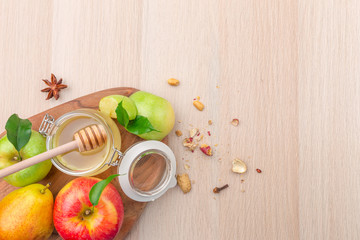 Jewish holiday Rosh Hashanah background with honey and apples on wooden table.