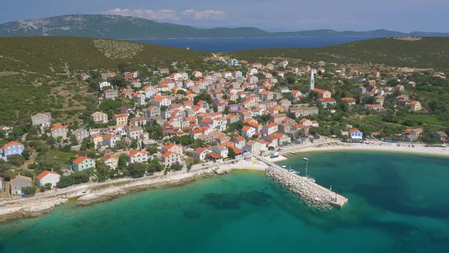 Aerial - Mediterranean island town Unije. Island Losinj in the background
