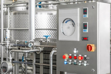 control panel with buttons and a tank at a beverage factory, close-up. factory shop for the...