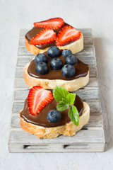 Toast bread with chocolate spread and berries strawberries blueb