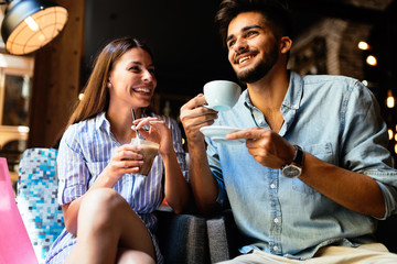 Young attractive couple on date in coffee shop