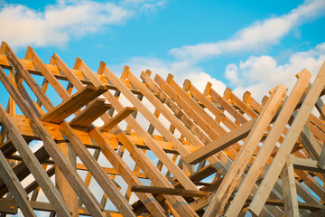 wooden roof construction, symbolic photo for home, home construction, and home financing