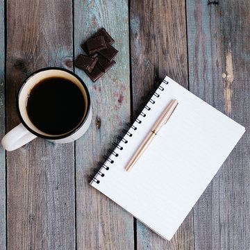 Cup Of Tea, Chocolate And A Notebook On A Wooden Table, Flatlay