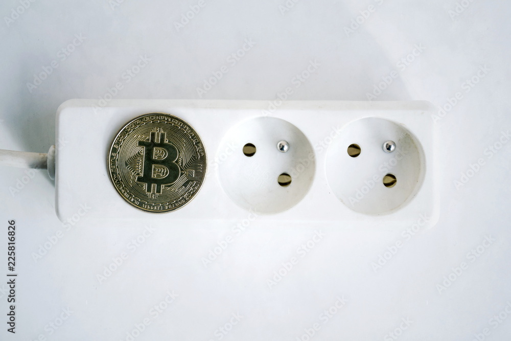 Wall mural bitcoin coin lying on power strip extension cord with two empty sockets, cryptocurrency investing, e