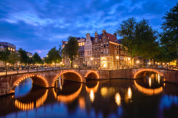 Amterdam canal, bridge and medieval houses in the evening