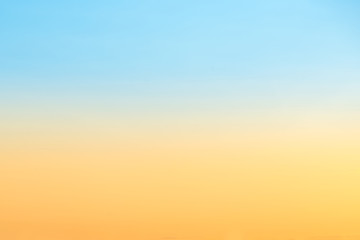 Sunset on blue and orange sky with sun and clouds