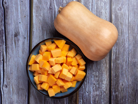 Butternut squash cubes on gray rustic background