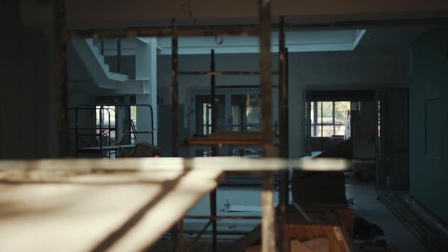 office is in repair white walls light burning building materials builder building construction contractor engineer industrial male renovation technician development design project slow motion