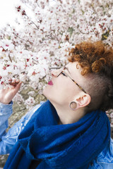 Young redhead woman surrounded by flowers
