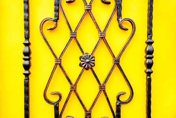 wrought iron fence ornament on yellow background
