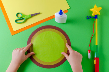 making of diy lantern for sankt martin, traditional german feast, childs hands and circles of color...