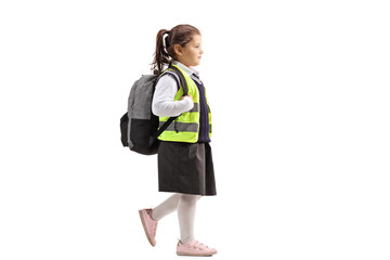 Schoolgirl wearing a safety vest walking