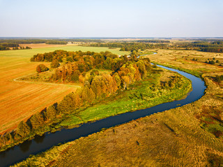 Agriculture view from above. Autumn woods, river and fields