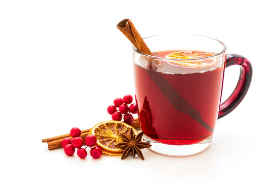 Hot red mulled wine isolated on white background with christmas spices, orange slice, anise and cinnamon sticks
