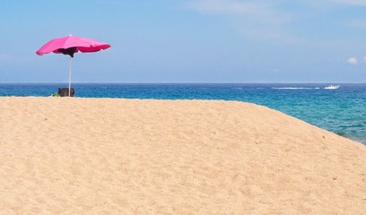 Pink parasol on a beach