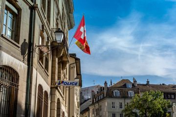 Police station and swiss flag as seen in Geneva, Switzerland