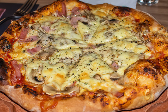 Close up view of a capricciosa style pizza