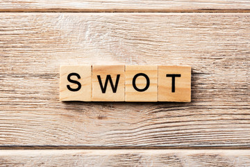 swot word written on wood block. swot text on table, concept