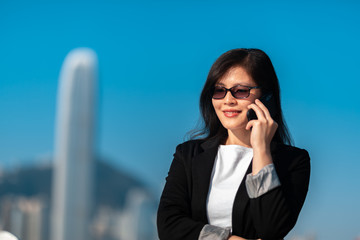 Business woman on the phone in Hong Kong waterfront