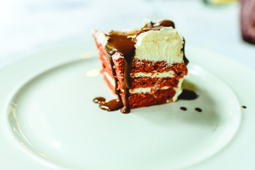 Piece of delicious chocolate cake on plate, deserved dessert for sweet tooth.