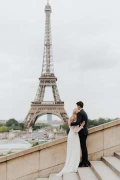 Bride and bridegroom, Eiffel Tower in background, Paris, France