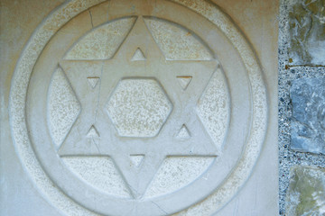 The Star of David engraved in the marble - traditional symbol of modern Jewish identity and Judaism