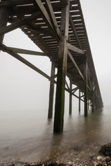 Old path leading to the sea in a fog.