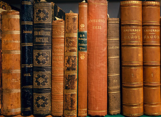 Selective focus on Hans Christian Andersen books printed in 19th century. Leather covers on...