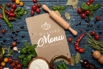 top view of fresh raw vegetables, spices, rolling pin and card with 